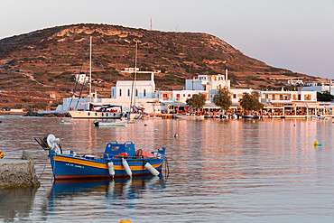 Fishing boat in harbour with town behind, Pollonia, Milos, Cyclades, Aegean Sea, Greek Islands, Greece, Europe