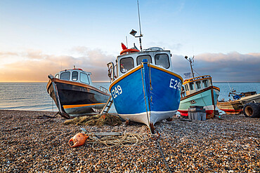 Fishing boats pulled up on shingle beach at sunrise, Beer, Jurassic Coast, Devon, England, United Kingdom, Europe