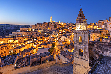 View over the Sassi di Matera old town with the campanile of the church of Saint Peter Barisano floodlit at dawn, Matera, Basilicata, Italy, Europe