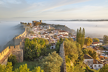 Fog at sunrise over Obidos old town and rampart defensive walls, Obidos, Centro Region, Estremadura, Portugal, Europe