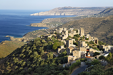 View over traditional tower houses and Mani coastline behind, Vathia, Mani, Peloponnese, Greece, Europe