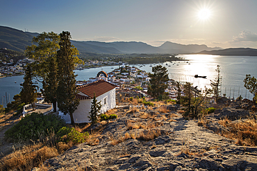 View over Poros town with Greek Orthodox chapel at sunset, Poros, Saronic islands, Greek Islands, Greece, Europe