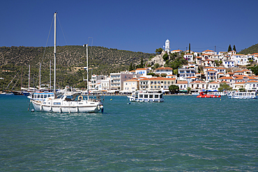 View of Poros town and clock tower from Galatas, Poros, Saronic islands, Greek Islands, Greece, Europe