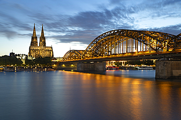 Hohenzollern bridge over the River Rhine and Cologne cathedral floodlit at night, Cologne, North Rhine Westphalia, Germany, Europe