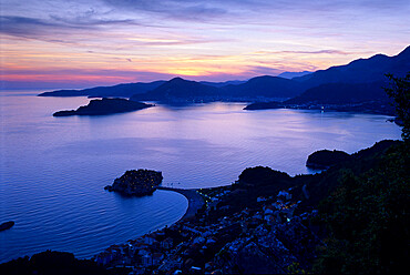 Sunset over Sveti Stefan and bay, Sveti Stefan, The Budva Riviera, Montenegro, Europe