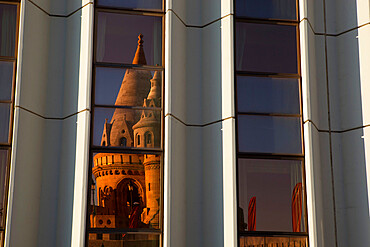 Fishermen's Bastion (Halaszbastya) reflected in windows of Hilton Hotel, Buda, Budapest, Hungary, Europe