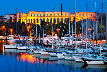 Dusk over marina and the Roman Amphitheatre, Pula, Istria, Croatia, Adriatic, Europe