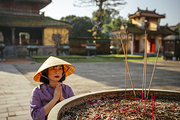 Woman making prayers at Buddhist Temple, Hue Historic Citadel, Hue, Thua Thien Hue, Vietnam