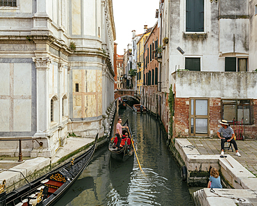 Gondola taking tourists along canals, Castello, Venice, Veneto, Italy