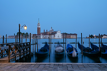 Goldolas on the lagoon at twilight, with San Giorgio Maggiore in the background, San Marco, Venice, Italy