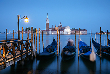 Goldolas on the lagoon at twilight, with San Giorgio Maggiore in the background, San Marco, Venice, Italy
