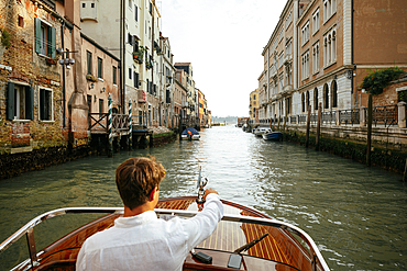 Speedboat water taxi through canals of Venice, Veneto, Italy