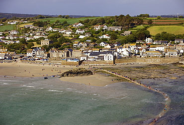 People crossing the tidal causeway from St. Michaels Mount to Marazion as the tide comes in, Cornwall, England, United Kingdom, Europe