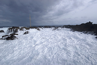 Wave crashing over tide pool, St. Peter and St. Paul's rocks, Brazil, South America