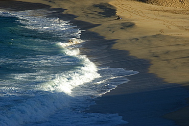 Surfer contemplates waves breaking in Waimea Bay Beach Park, North shore, Oahu, Hawaii, United States of America, Pacific