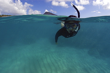 Split image of snorkeller hovering over sandy substrate, Hanauma Bay, Oahu, Hawaii, United States of America, Pacific