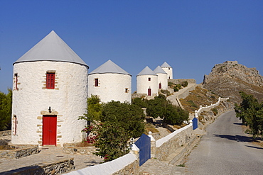 Row of old windmills on Pitiki Hill below Panteli castle, Platanos, Leros, Dodecanese Islands, Greek Islands, Greece, Europe