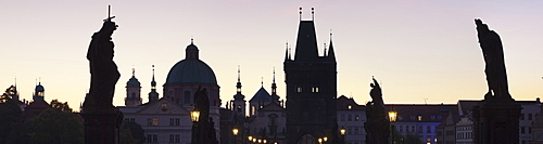 Silhouette of Statues on Charles Bridge, UNESCO World Heritage Site, Dome of St. Francis Church and Old Town Bridge Tower, Prague, Bohemia, Czech Republic, Europe 