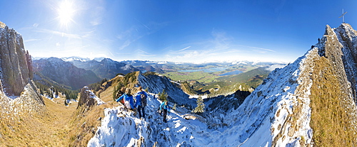 Climbers on steep crest covered with snow in the Ammergau Alps, Tegelberg, Fussen, Bavaria, Germany, Europe