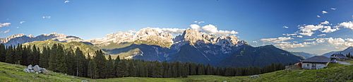 Panorama of meadows and hut framed by peaks, Malga Ritorto, Madonna di Campiglio, Brenta Dolomites, Trentino-Alto Adige, Italy, Europe