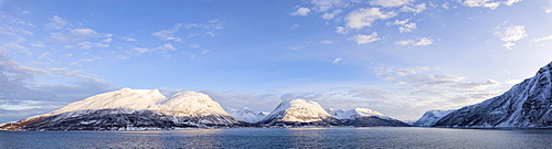 Panorama of snowy peaks surrounded by frozen sea, Olderdalen, Kafjorden, Lyngen Alps, Troms, Norway, Scandinavia, Europe