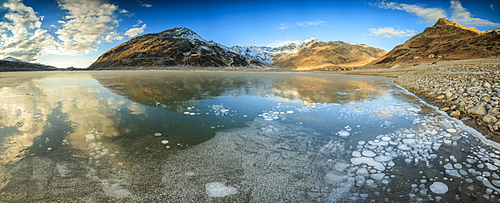 Panoramic of frozen lake Montespluga at dawn, Chiavenna Valley, Sondrio province, Valtellina, Lombardy, Italy, Europe