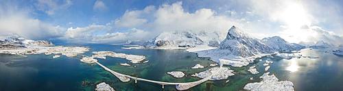 Aerial panoramic view of snowy peak of Volanstinden and Fredvang bridge, Lofoten Islands, Nordland, Norway, Europe