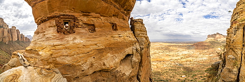 Aerial panoramic by drone of priest looking out from Abuna Yemata Guh rock-hewn church, Gheralta Mountains, Tigray region, Ethiopia, Africa