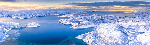 Arctic sunrise over the frozen sea and mountains covered with snow, Laksefjorden, Lebesby, Kunes, Troms og Finnmark, Norway, Scandinavia, Europe