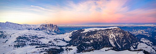 Sunrise over Sciliar Massif and Compatsch village covered with snow, aerial view, Seiser Alm, Dolomites, South Tyrol, Italy, Europe