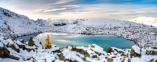 Sunrise over the snowcapped Orobie Alps and frozen lake Rogneda during a cold autumn, Rhaetian Alps, Lombardy, Italy, Europe