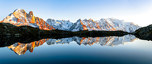 Panoramic of Mont Blanc Massif covered with snow reflected in Lacs de Cheserys at sunset, Chamonix, Haute Savoie, French Alps, France, Europe