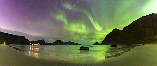 Panoramic of the frozen Haukland beach under a multicolored sky with Aurora Borealis (Northern Lights), Lofoten Islands, Nordland, Norway, Scandinavia, Europe