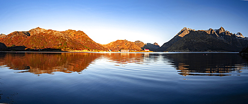 Autumn sunrise over mountains and coastal village of Sildpollnes, Austnesfjorden, Svolvaer, Lofoten Islands, Nordland, Norway, Scandinavia, Europe