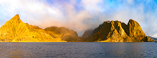 Panoramic of Olstind and Festhelltinden mountains in the mist at dawn, Reine, Lofoten Islands, Nordland, Norway, Scandinavia, Europe