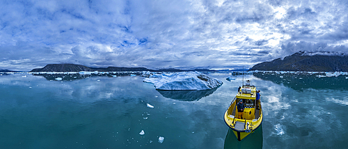 Aerial of a little boat anchoring in the Nuuk Icefjord, Western Greenland, Denmark, Polar Regions