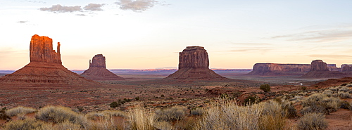 The giant sandstone buttes glowing pink at sunset in Monument Valley Navajo Tribal Park on the Arizona-Utah border, United States of America, North America