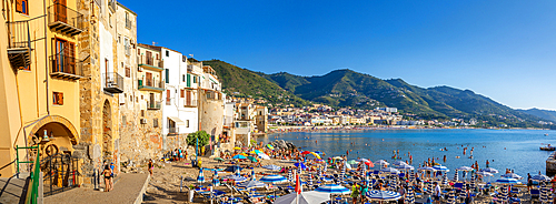 Panoramic view of tourists on beach, mountains in background, Cefalu, Province of Palermo, Sicily, Italy, Mediterranean, Europe