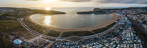 Aerial drone panoramic view at sunset of Sao Martinho do Porto bay, shaped like a scallop with calm waters and fine white sand, Oeste, Portugal, Europe