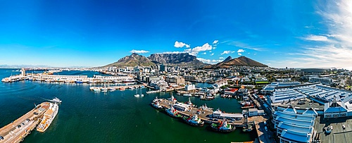 Aerial drone panoramic view of the V and A (Victoria and Alfred) Waterfront, a mixed-use destination located in the oldest working harbour in the Southern Hemisphere,with Table Mountain as backdrop, Cape Town, Western Cape, South Africa, Africa