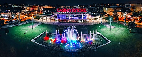 Aerial drone panoramic view of Casino Estoril at night, the inspiration of Ian Fleming's Casino Royale, Estoril, Portugal, Europe