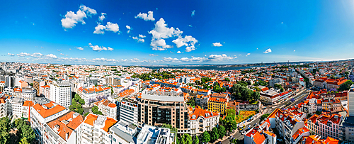 Aerial drone panoramic view of Lisbon's Baixa district on a sunny day looking south towards the Tagus with the 25 April Bridge visible, Lisbon, Portugal, Europe