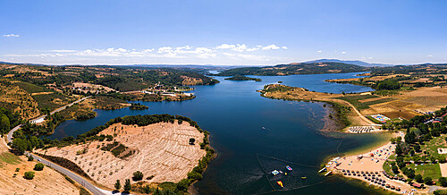 Aerial drone panoramic view of Azibo Reservoir Protected Landscape (Paisagem Protegida da Albufeira do Azibo) near Braganca, Portugal with many beaches and great infrastructure for families