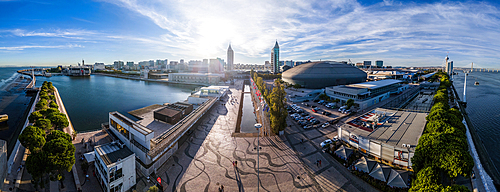 Aerial drone panoramic view of Oriente Train station and general view of Parque das Nacoes in Lisbon, Portugal at sunset