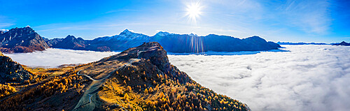 Valmalenco ski slopes with autumn colors and clouds covered Valmalenco valley, Valtellina, Lombardy, Italy, Europe