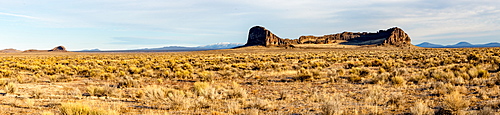 A panorama of sagebrush and rock formations in front of mountains, Oregon, United States of America, North America