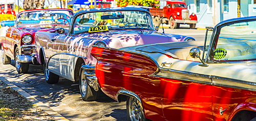 A row of classic American cars used as taxis in Varadero, Cuba, West Indies, Caribbean, Central America