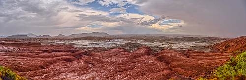 A heavy rainstorm over a section of Petrified Forest National Park Arizona called the Flattops. Because the rain was falling at the time of this photo some falling rain has been captured in the photo.