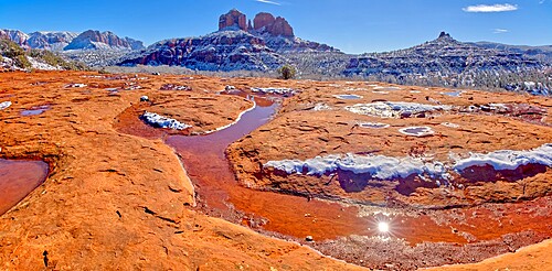 Snow covered Cathedral Rock in Sedona viewed from a sandstone plateau along Secret Slick Rock Trail, Arizona, United States of America, North America