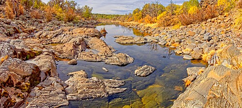 Reflecting pools and volcanic basalt rock boulders in the water, Devil Dog Canyon, near Drake, Arizona, United States of America, North America